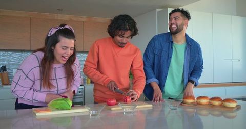 Friends Preparing Casual Brunch at Kitchen Island Laughing and Chopping Vegetables Together