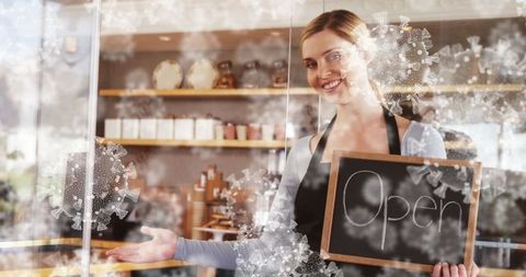 Smiling Barista Holding Open Sign in Cozy Café with Safety Decals - Download Free Stock Images Pikwizard.com