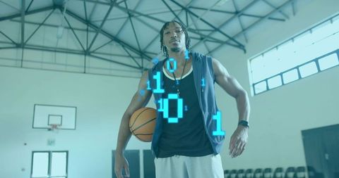 Standing basketball player holding ball with holographic binary code in gym digital sports