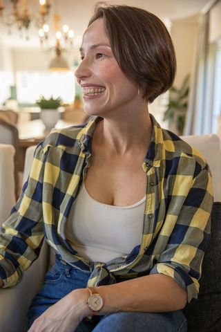 Captivating Mature Woman Smiling with Serene Home Ambiance