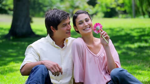 Couple Smiling in Park During Romantic Picnic