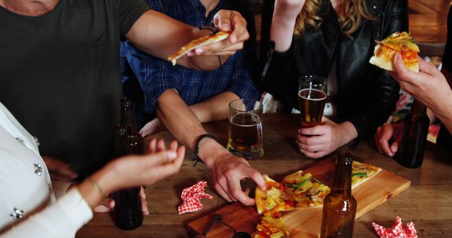 Friends Enjoying Pizza and Beer at Casual Gathering - Download Free Stock Images Pikwizard.com