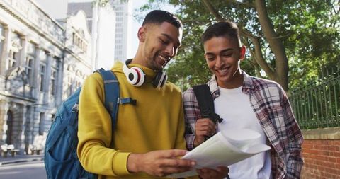 Two Friends Using Map in Urban Travel Adventure