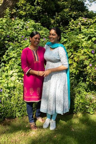 Mother and Daughter Laughing Together in Sunny Backyard