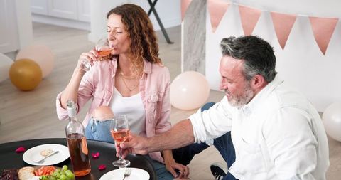 Couple Celebrating with Wine Indoors Festive Mood