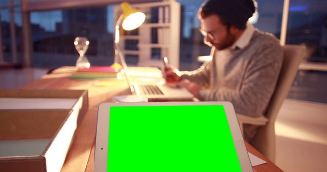 Man Working Late with Laptop and Tablet with Green Screen - Download Free Stock Images Pikwizard.com