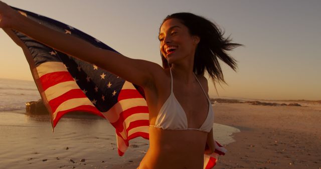 Joyful Woman Holding American Flag at Sandy Beach Sunset - Download Free Stock Images Pikwizard.com