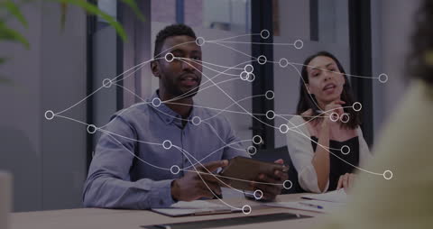 Diverse Team Collaborating with Digital Network Visualization in Office