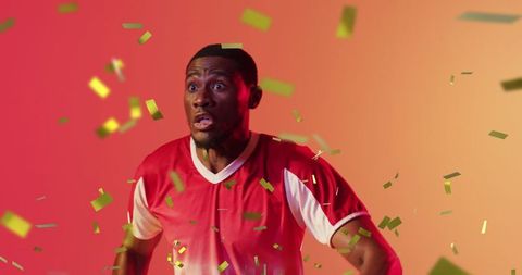 Overjoyed Sportsman Revels Amidst Floating Green Confetti Stream
