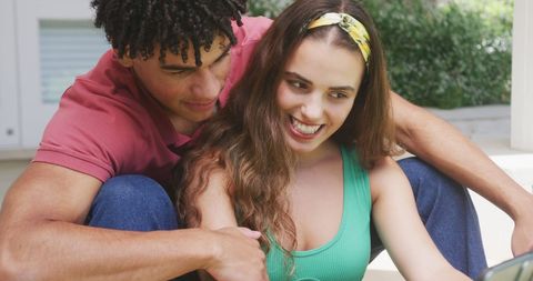 Happy couple cuddling at home taking a selfie