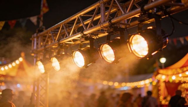 Amber Stage Lights on Truss Casting Haze Over Night Festival Crowd