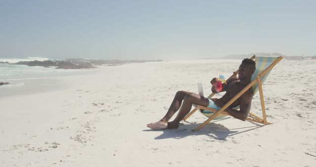 Young Man Relaxing on Beach With Tropical Drink - Download Free Stock Images Pikwizard.com