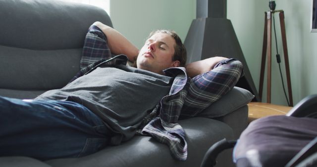 Young Man Relaxing on Sofa in Casual Home Setting - Download Free Stock Images Pikwizard.com