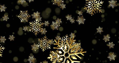 Golden snowflakes floating against dark background