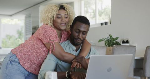 Happy Couple Using a Laptop Together at Home