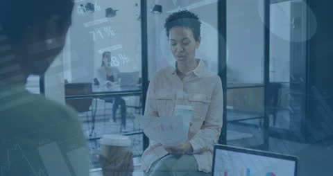 Diverse Team Discusses Reports with Coffee in Modern Office
