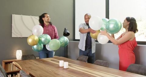 Multiracial friends cleaning party decorations