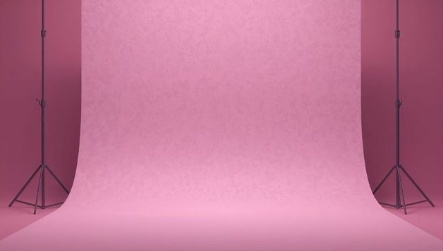 Seamless blush pink cyclorama with curved floor and twin tripod stands for product shoots