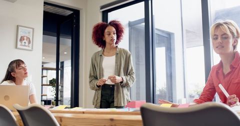 Empowered Women Leading Collaborative Business Meeting at Modern Office