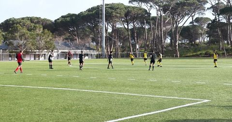 Youth soccer game with players in action at city field
