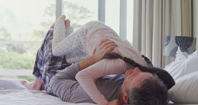 Father and daughter playing on bed in cozy bedroom - Download Free Stock Images Pikwizard.com