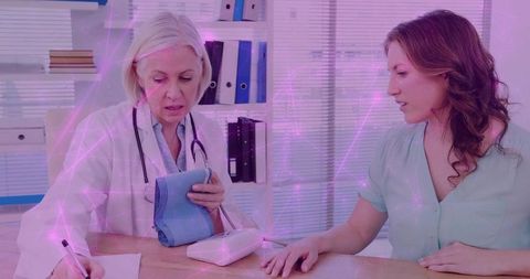 Doctor measures blood pressure of female patient in modern clinic