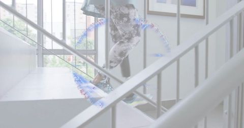 Senior woman climbing stairwell in patterned leggings with motion light artifact