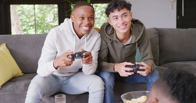 Happy Friends Playing Video Games on Sofa - Download Free Stock Images Pikwizard.com