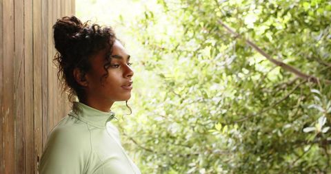 Woman in Light Green Activewear Contemplating Nature Outdoors