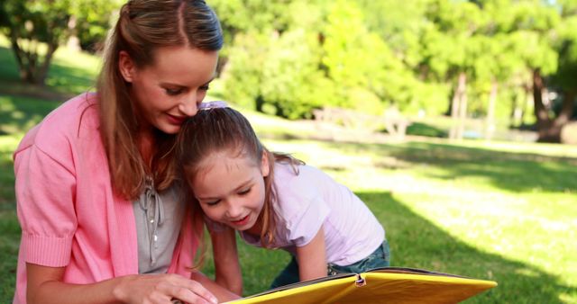 Mother and Daughter Reading Storybook in Park - Download Free Stock Images Pikwizard.com