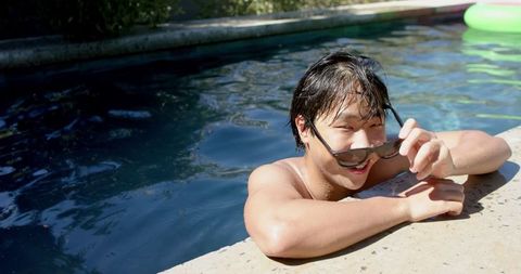 Asian Young Man Relaxing in Swimming Pool with Sunglasses - Download Free Stock Images Pikwizard.com