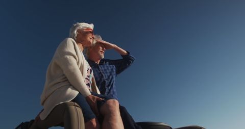 Senior Couple Enjoying Sunset on Romantic Road Trip