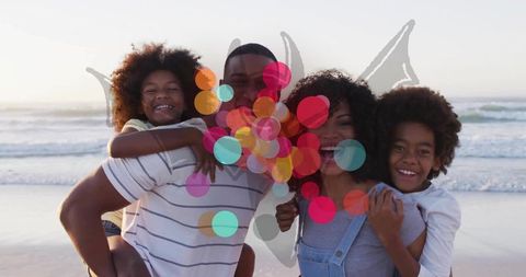 Joyful Family Piggybacking at Beach Together During Sunset