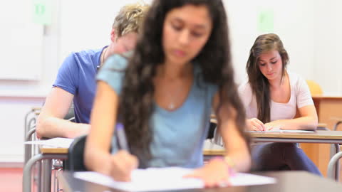 Focused Students Writing in Classroom During Examination
