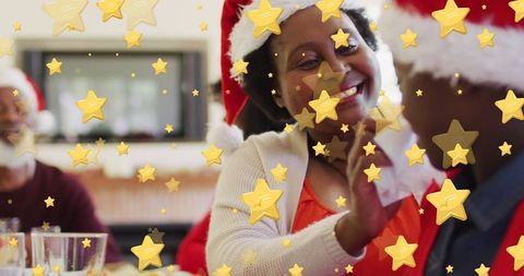 Joyful Family in Santa Hats Celebrating Festive Holiday with Stars