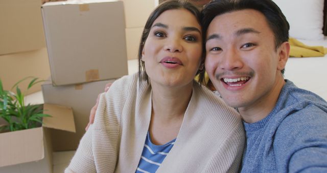 Image of happy diverse couple taking selfie in new house. love, relationship, moving and starting new life together concept.