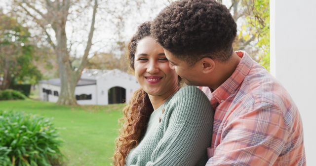 Image of smiling biracial couple spending time in the garden. Domestic lifestyle and leisure time in the garden.