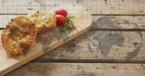 Artisanal Hand Pies with Fresh Tomatoes and Rosemary on Wood Table