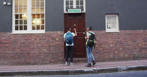 Young Travelers Finding Hostel Entrance in Urban Area - Download Free Stock Images Pikwizard.com