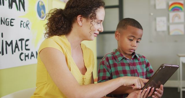 Teacher and Student Using Tablet for Classroom Activity on Climate Change - Download Free Stock Images Pikwizard.com