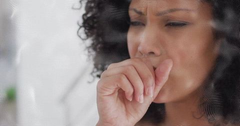 Woman coughing behind dotted mesh for health and protection theme