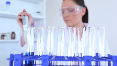 Female Scientist Conducting Experiment in Laboratory