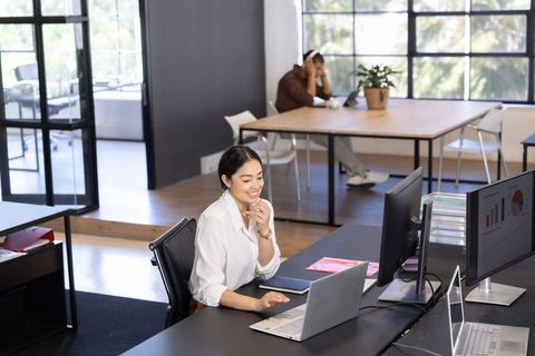 Diverse Professionals Collaborating in Modern Open-Plan Office Environment