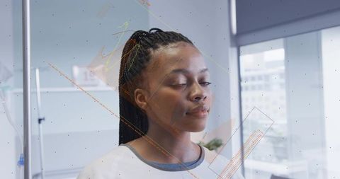 Young woman with braided hair meditating in modern office with soft light