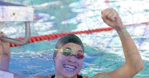 Triumphant competitive swimmer celebrates victory in pool