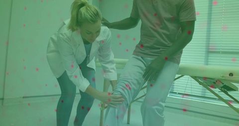 Physical therapist assisting patient during knee rehabilitation therapy