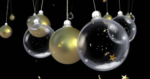 Elegant glass and gold baubles with drifting star confetti