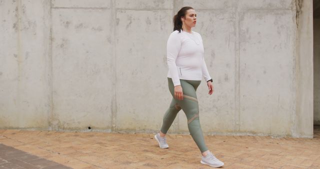 Woman Walking for Fitness in Urban Setting - Download Free Stock Images Pikwizard.com