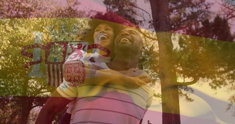 Couple Laughing Piggyback in Sunlit Park with Spanish Flag Overlay, Romantic Joyful Moment
