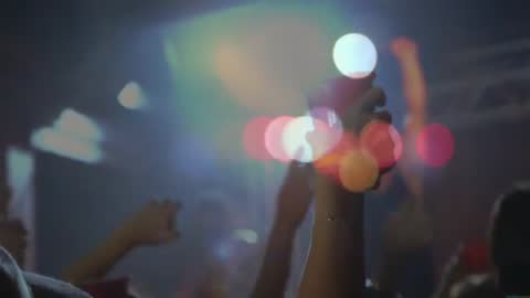 Hands Raising Red Cups Enthusiastically at Energetic Concert